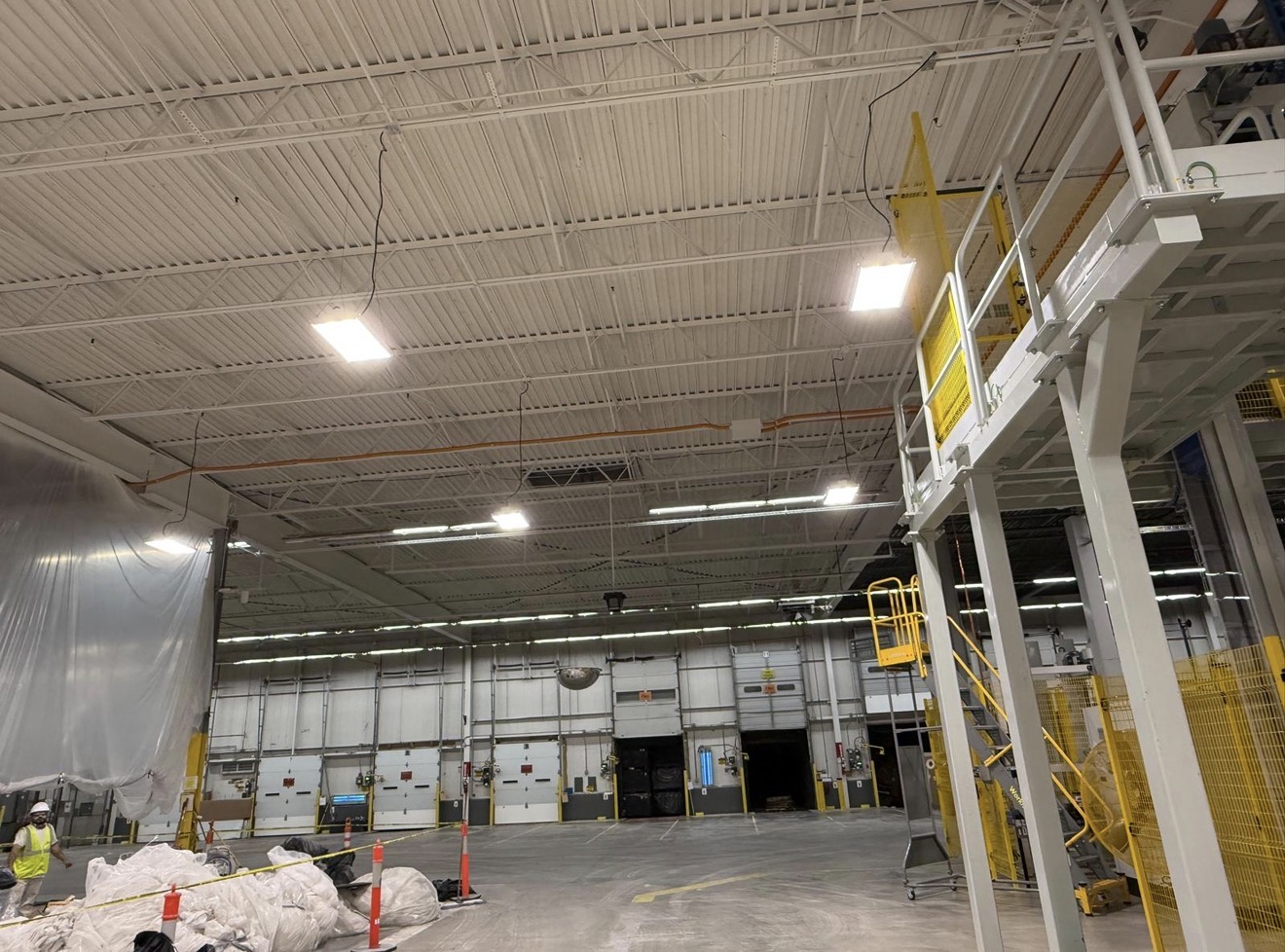 High-bay protective coating application inside industrial warehouse